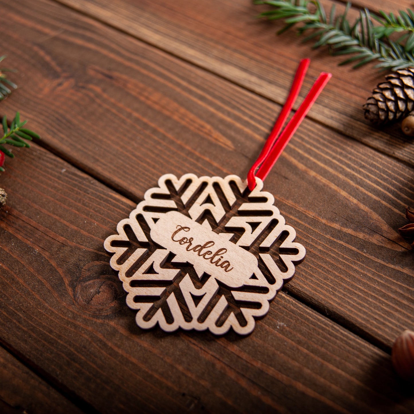Laser cut wooden snowflake ornament hanging on Christmas tree