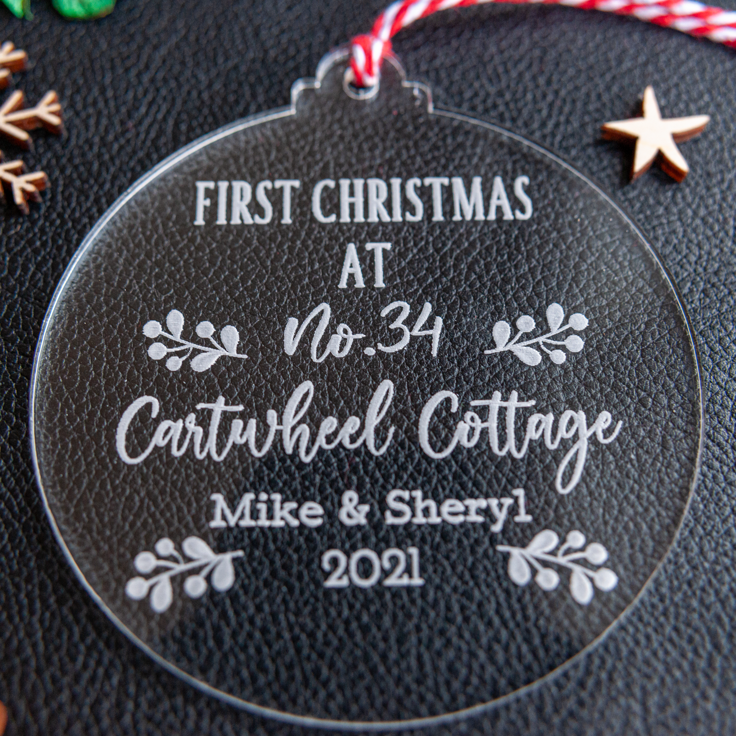 Laser cut acrylic bauble engraved with family name and year
