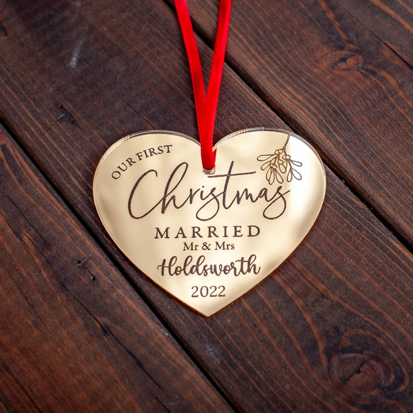 Elegant gold heart ornament engraved with Our First Christmas