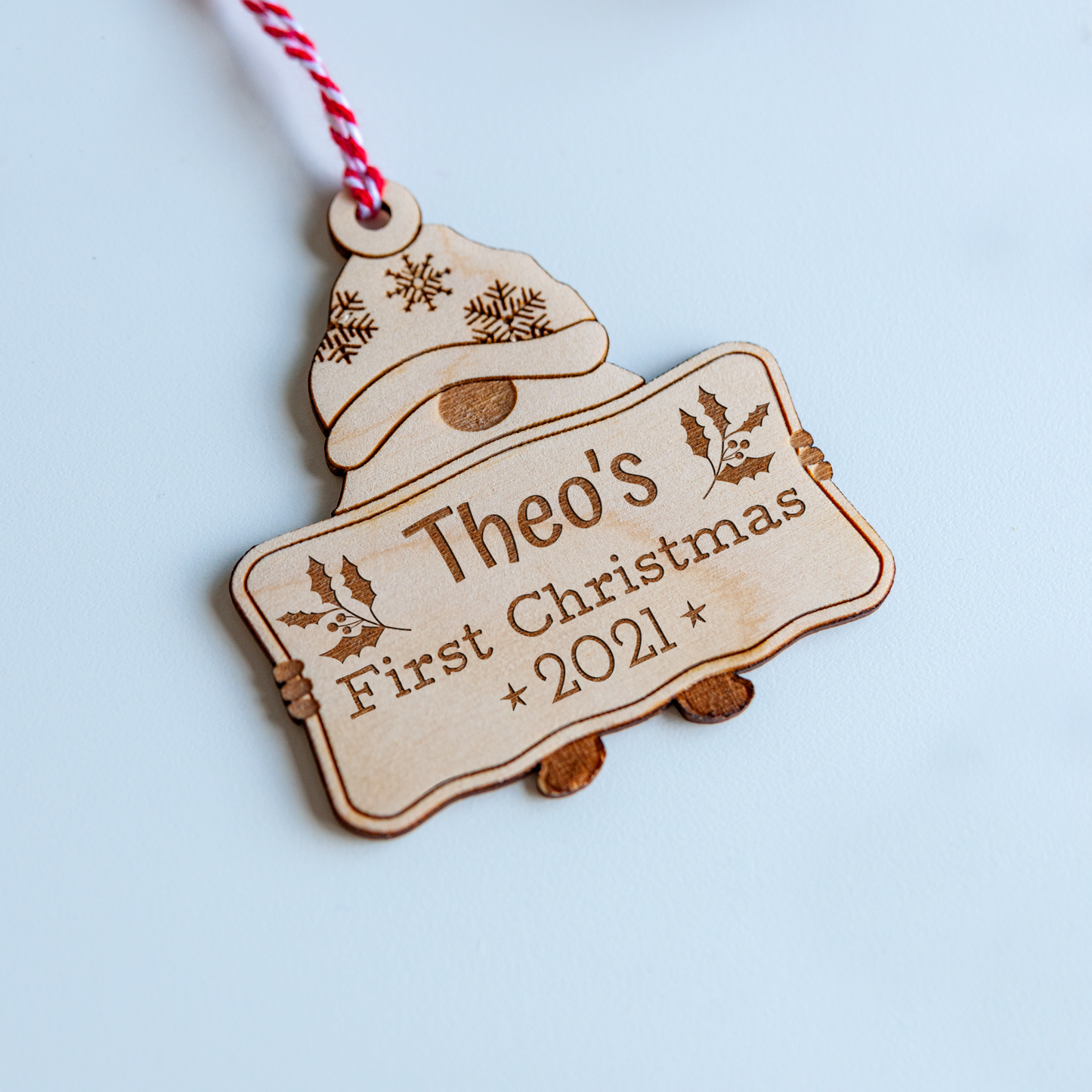 Engraved wood gnome ornament for baby’s first Christmas with ribbon