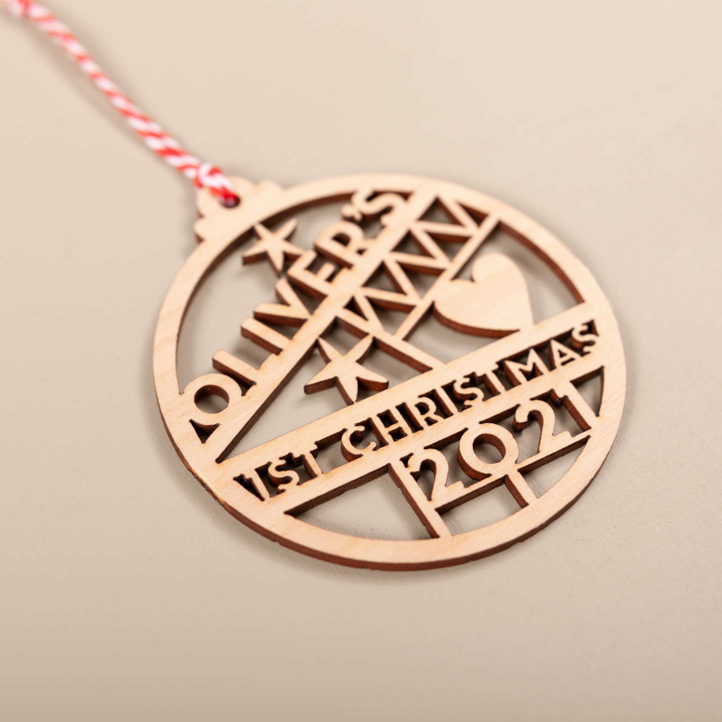 Wooden cut-out name bauble personalised for baby’s first Christmas