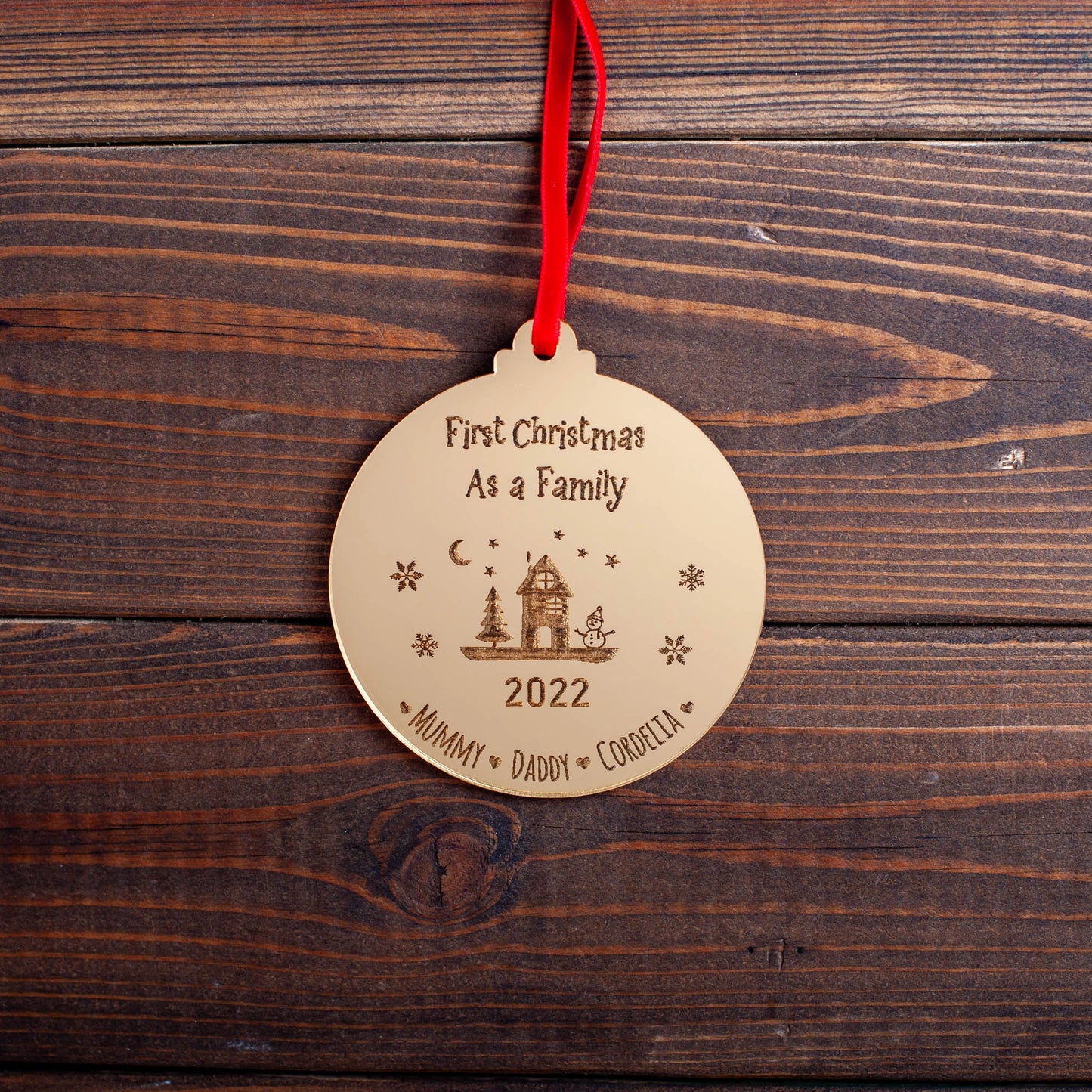 Engraved gold acrylic bauble for family’s first Christmas