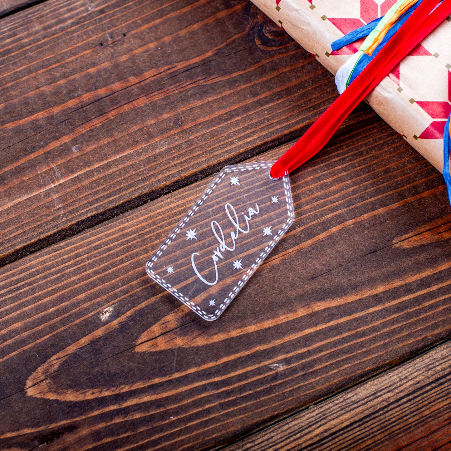 Engraved clear acrylic gift label with festive star pattern