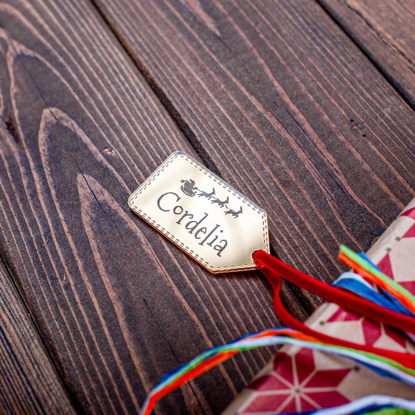 Engraved Santa and sleigh design on gold mirror tag