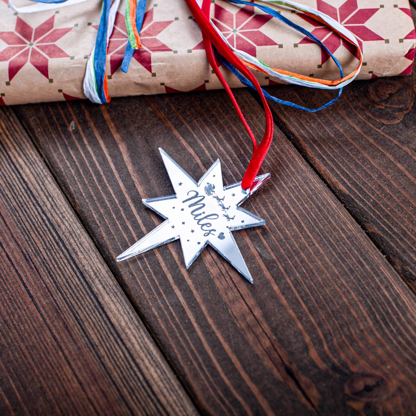 Engraved silver mirror star tag on Christmas gift box