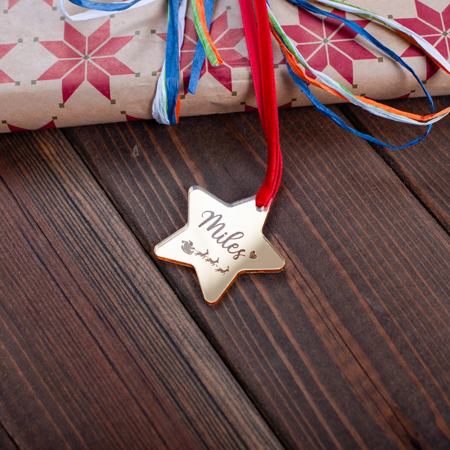 Custom engraved Santa and sleigh star tag on festive gift