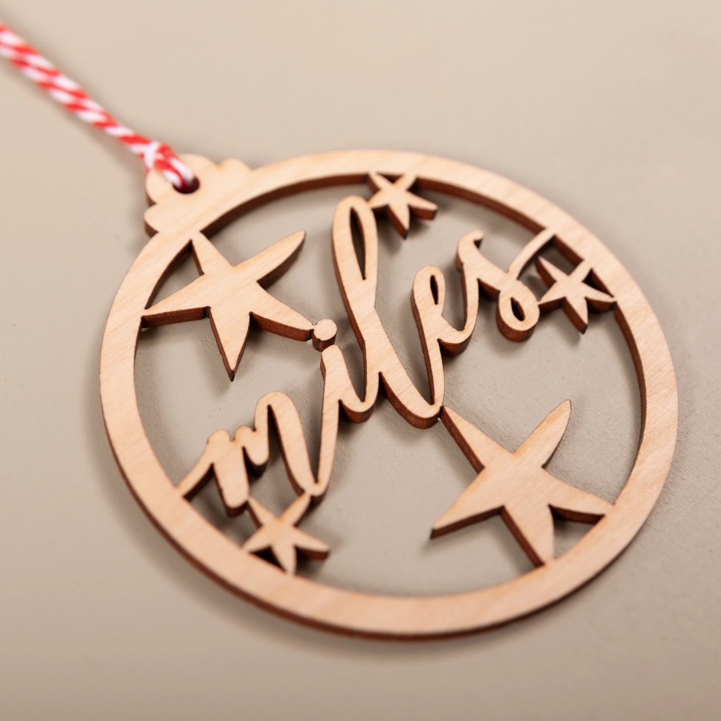 Close-up of custom wooden name bauble showing stars and name