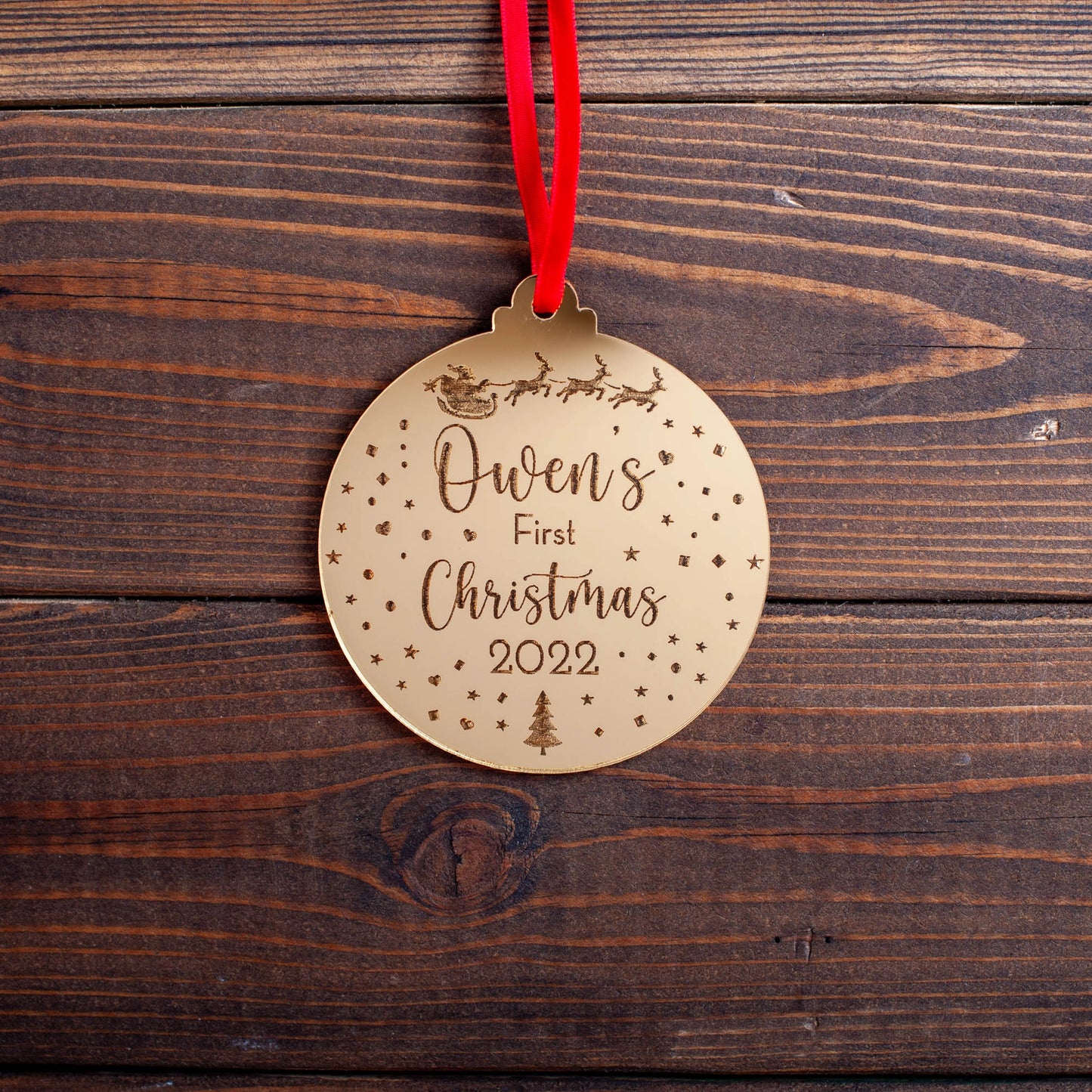 Gold mirror baby’s first Christmas bauble with engraved sleigh design