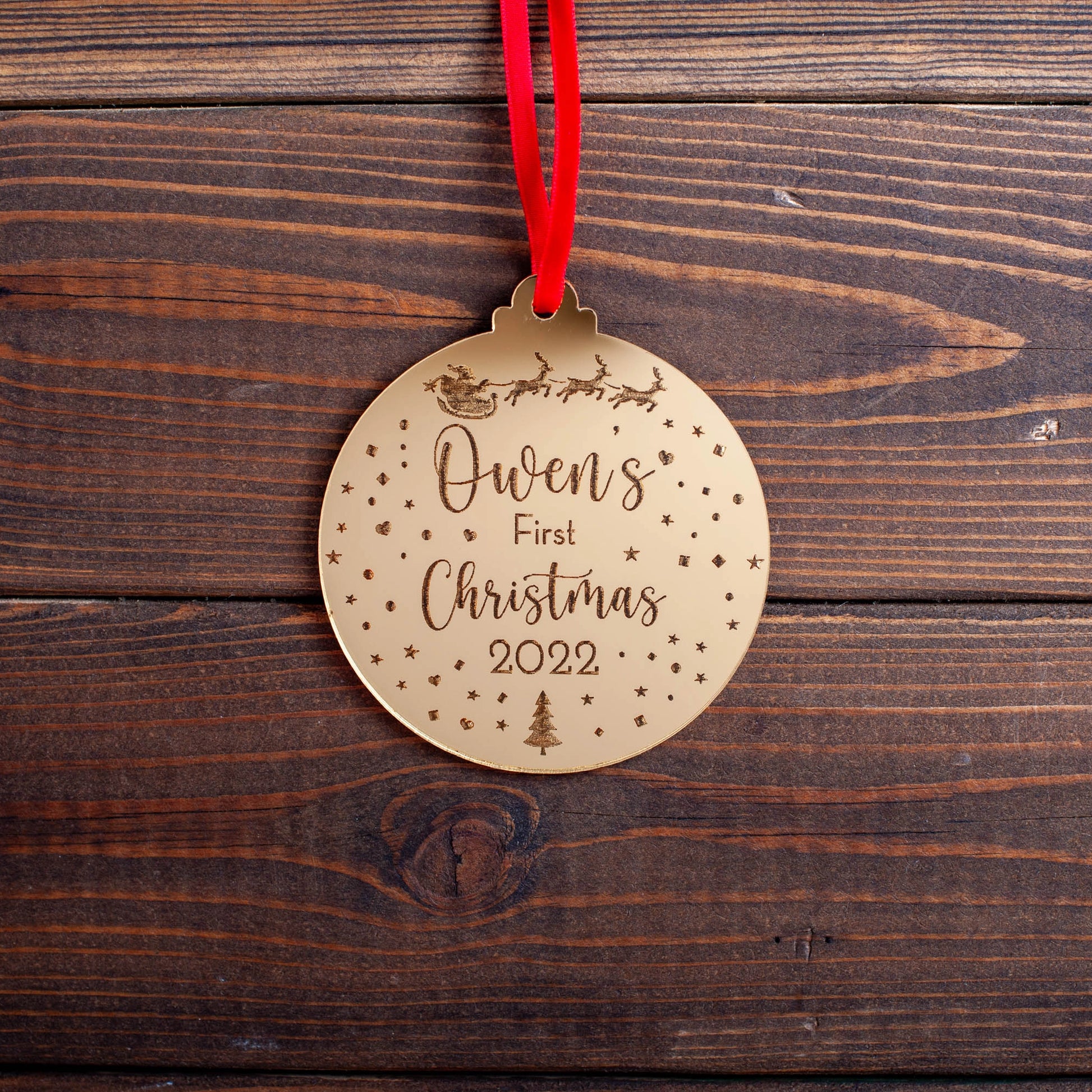 Gold mirror baby’s first Christmas bauble with engraved sleigh design