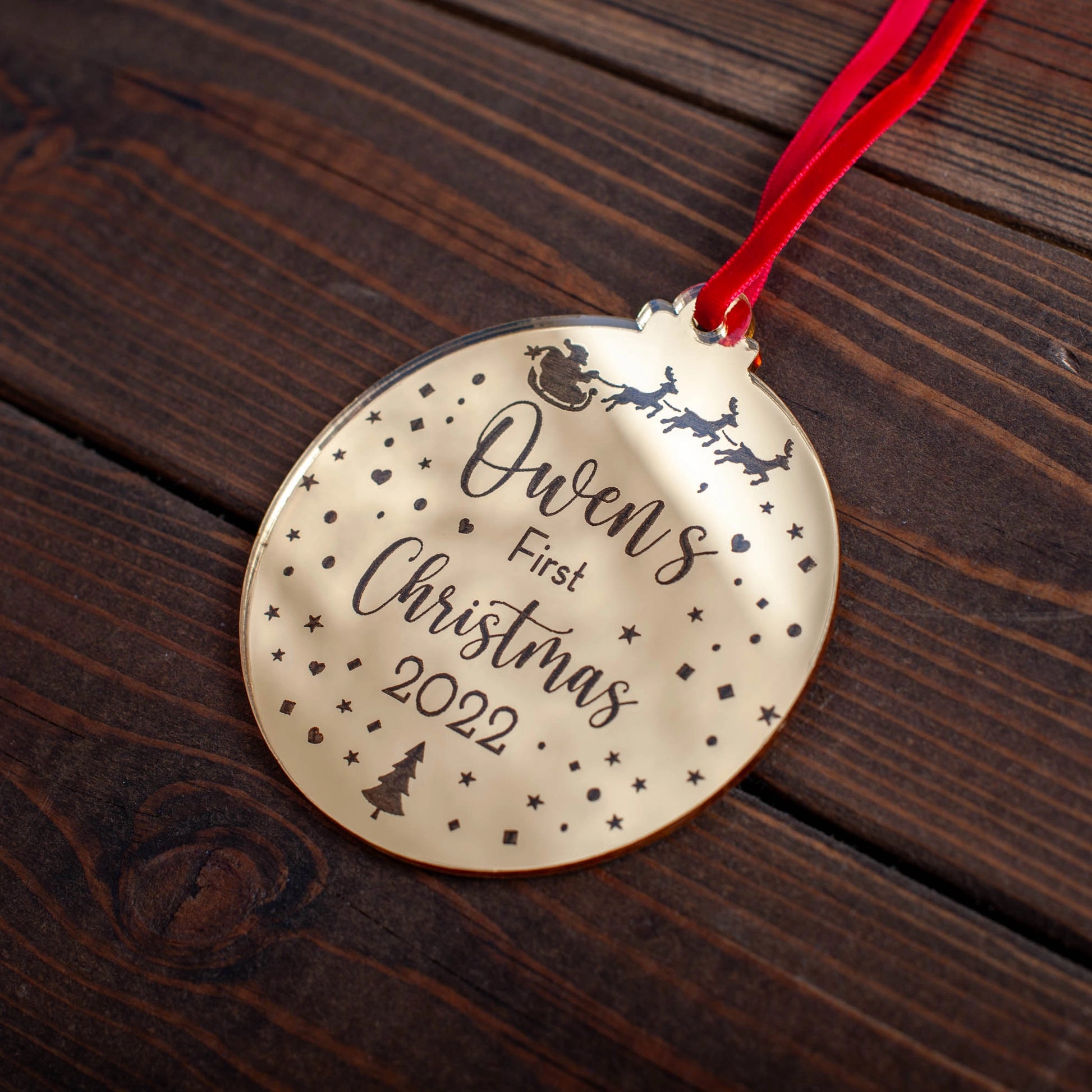 Baby’s first Christmas ornament engraved with Santa sleigh and name