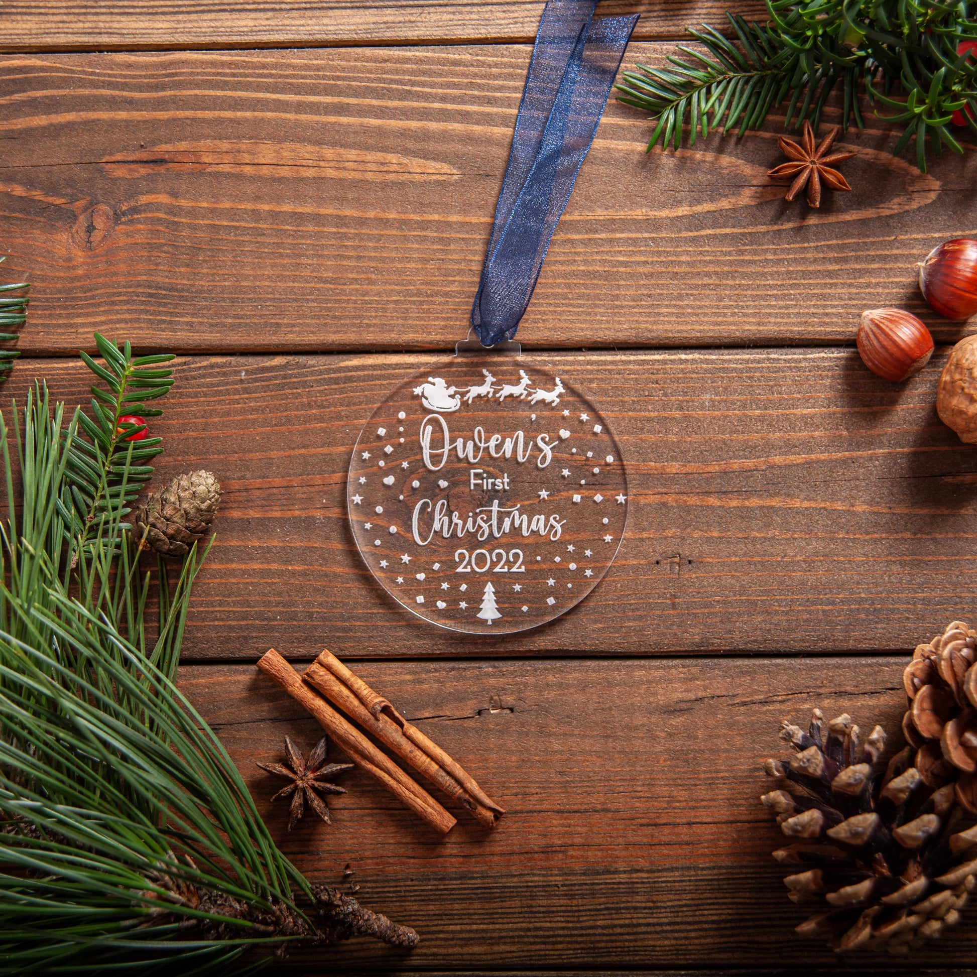 Acrylic baby ornament featuring engraved Santa sleigh design