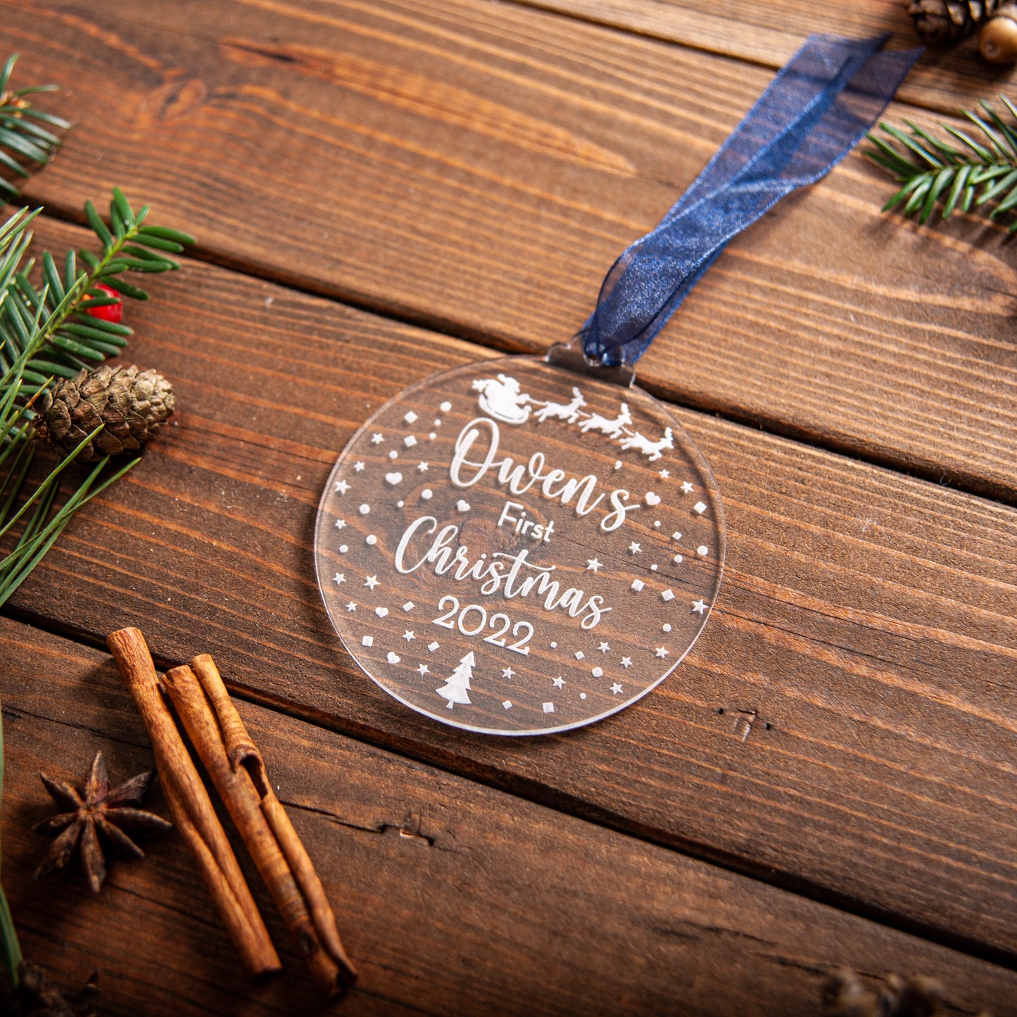 Engraved acrylic bauble featuring Santa sleigh design for baby’s first Christmas