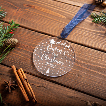 Engraved acrylic bauble featuring Santa sleigh design for baby’s first Christmas