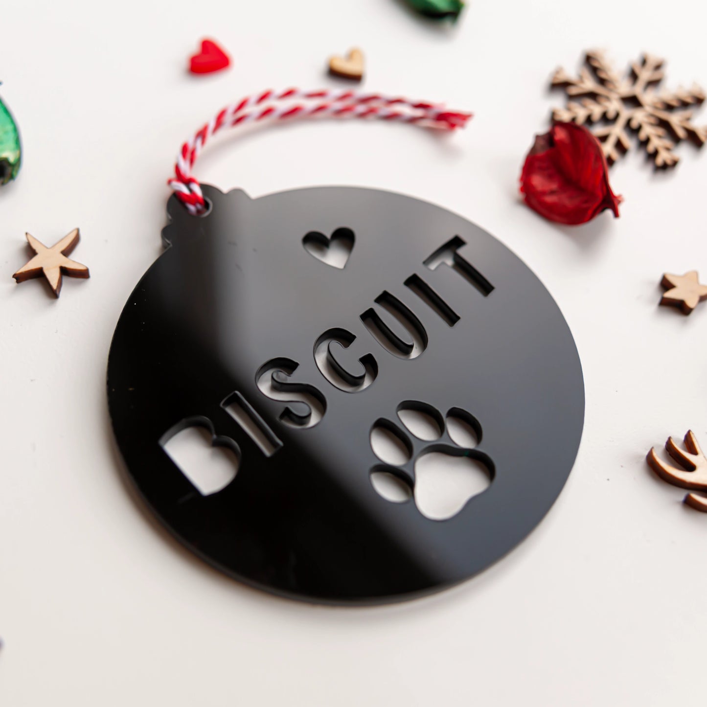 Laser cut black acrylic ornament with paw design and pet name