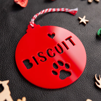Personalised red acrylic pet name bauble hanging on tree