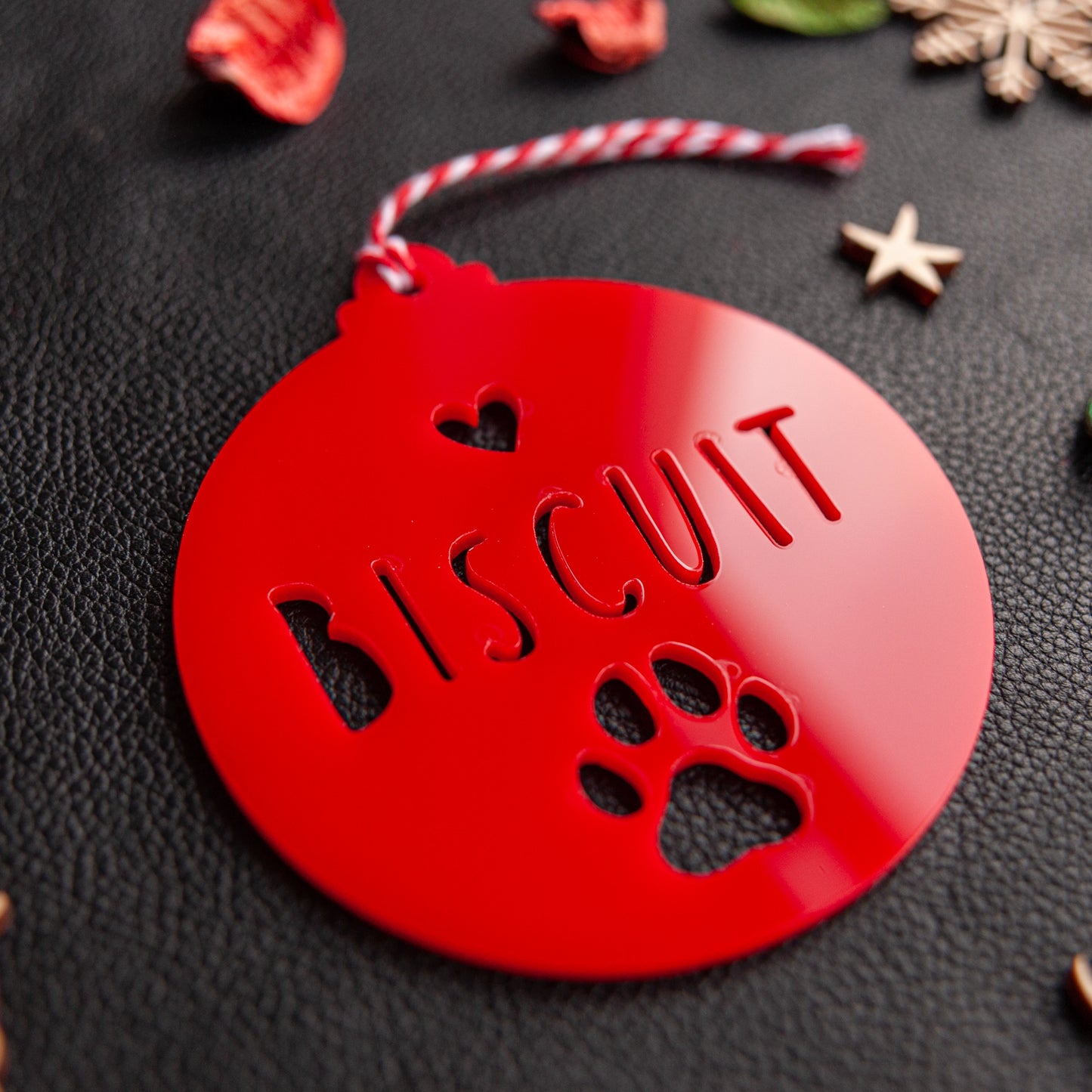 Engraved pet name paw ornament with red satin ribbon