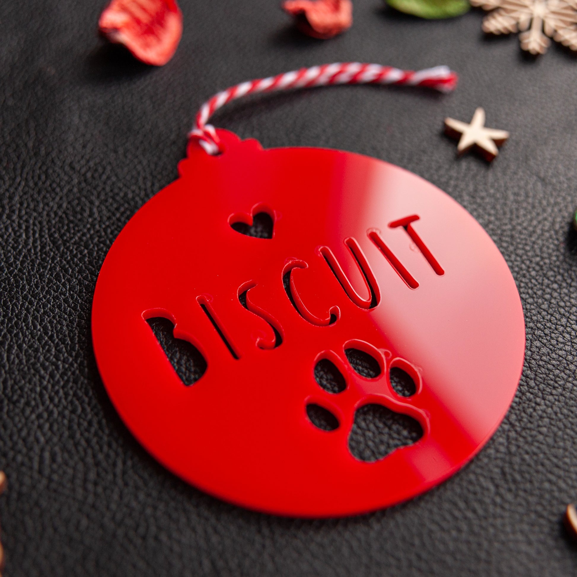 Engraved pet name paw ornament with red satin ribbon
