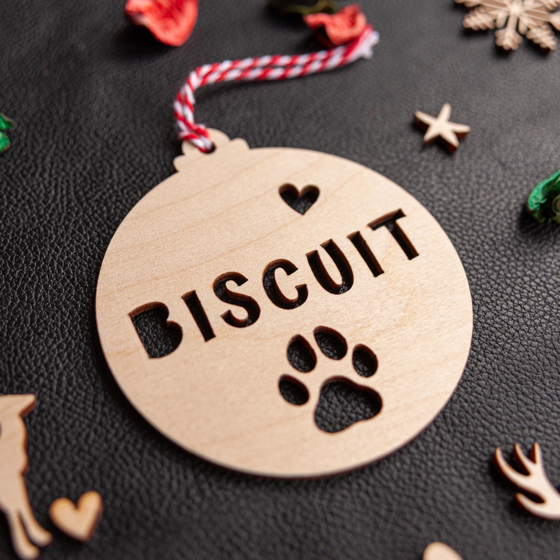 Laser cut wooden ornament with paw cut-out design