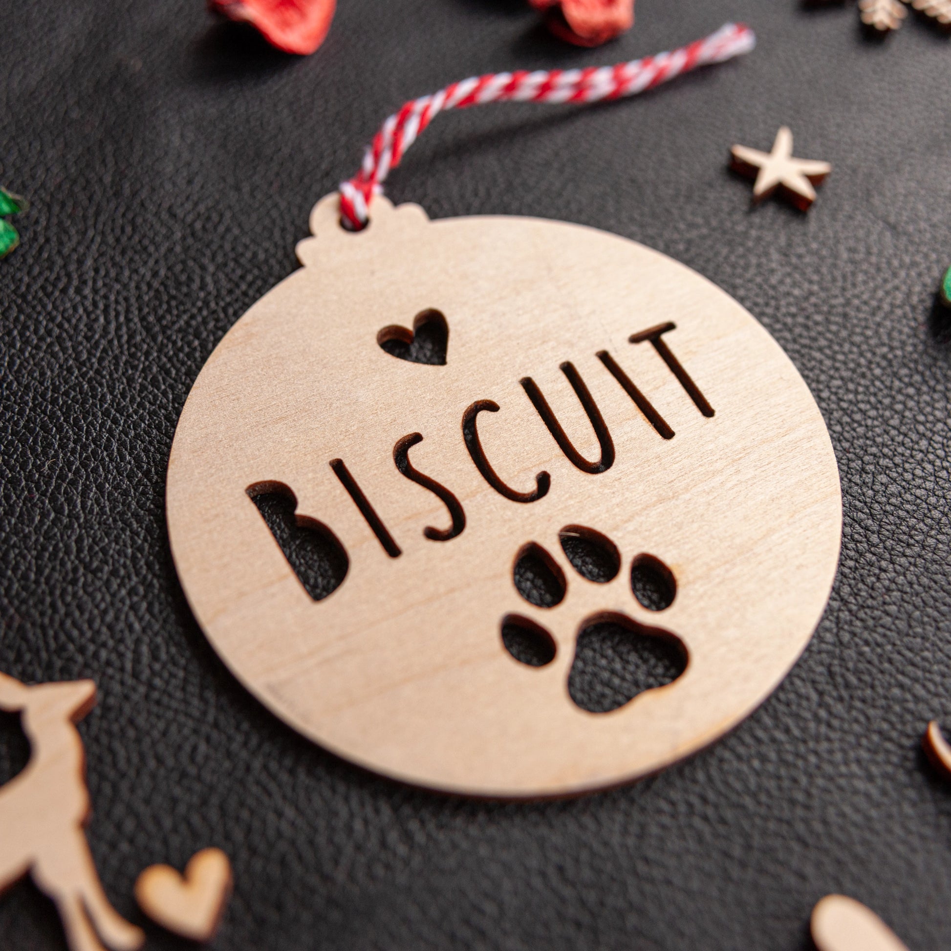 Engraved pet name paw decoration hanging on Christmas tree