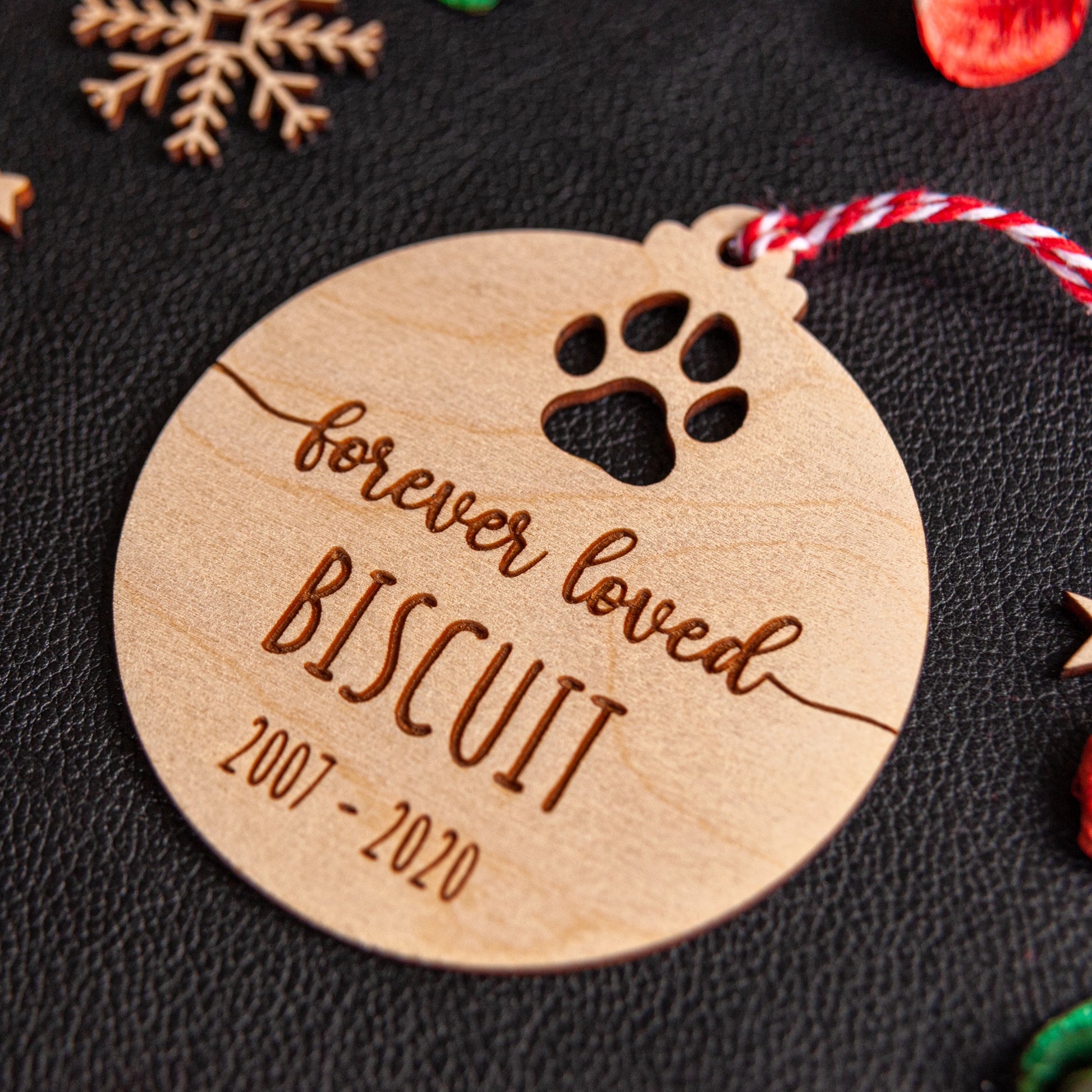 Custom wooden bauble with pet name and paw design