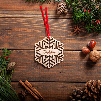 Personalised wooden snowflake cut out Christmas bauble with engraved name