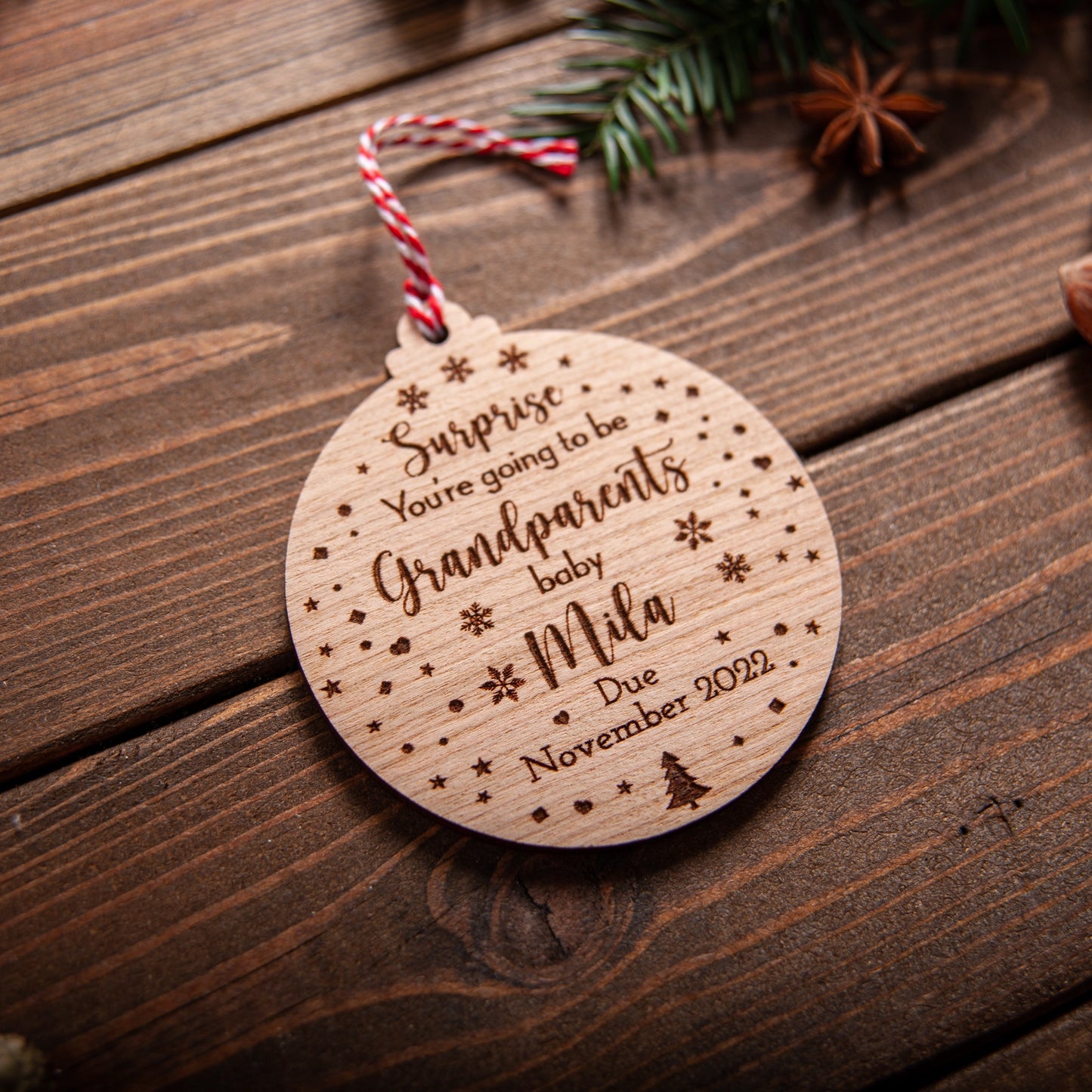 Custom engraved pregnancy reveal bauble for grandparents hanging on tree