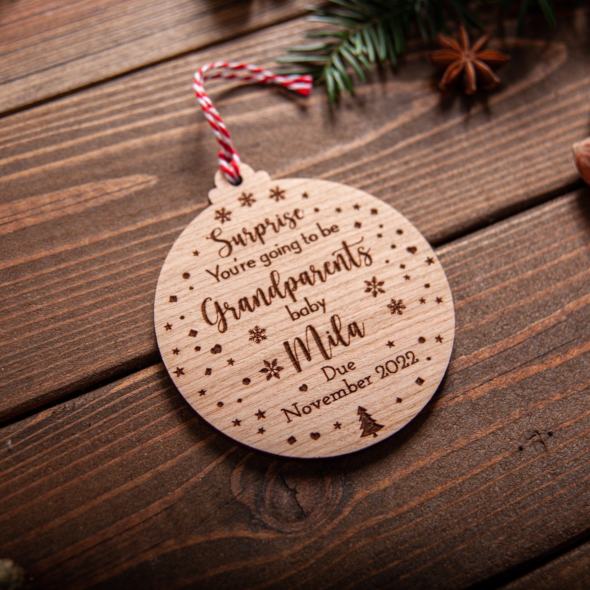 Custom engraved pregnancy reveal bauble for grandparents hanging on tree