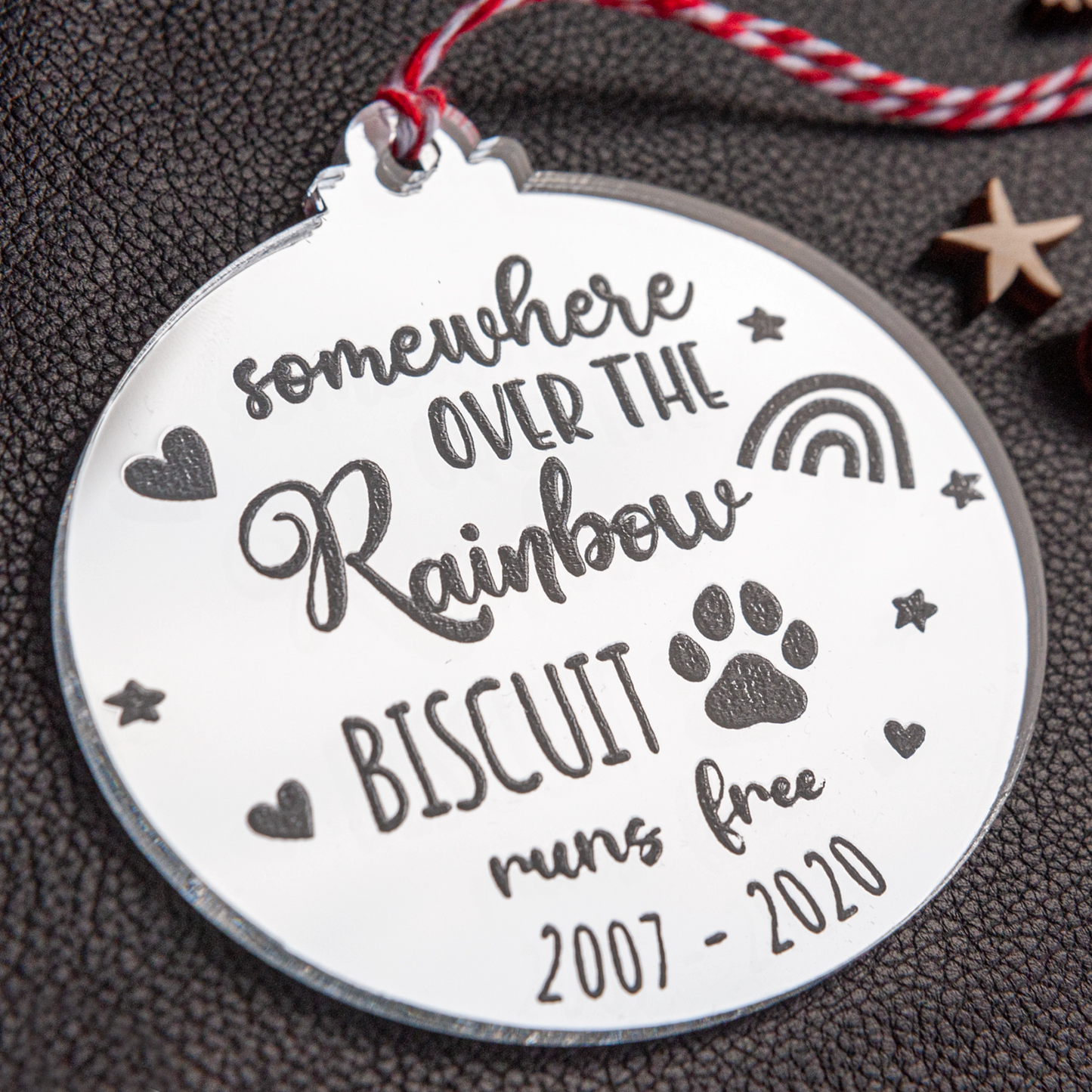 Silver mirror pet memorial ornament reflecting Christmas lights