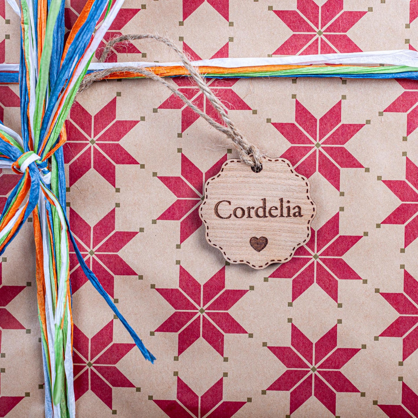 Engraved wooden bauble-shaped tag for Christmas gift wrapping décor