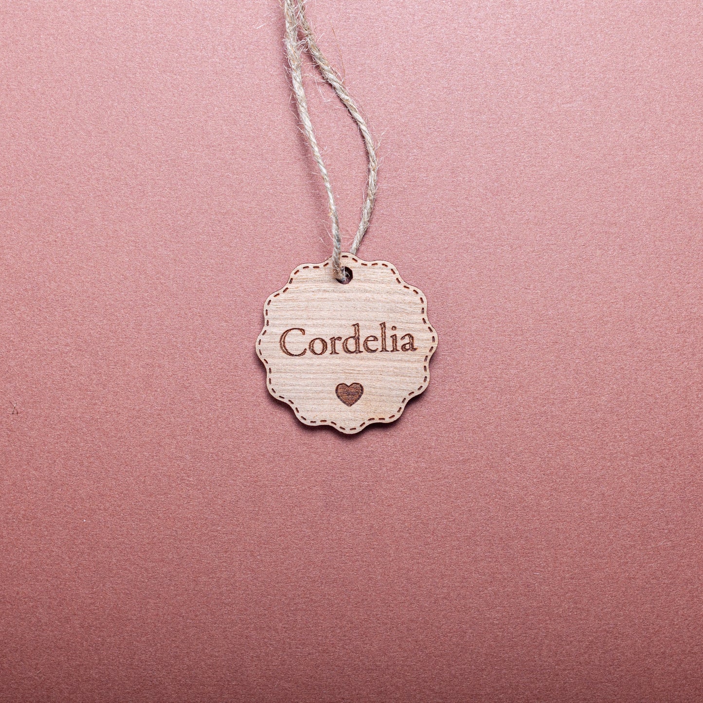 Rustic personalised bauble-shaped wooden tag for holiday wrapping