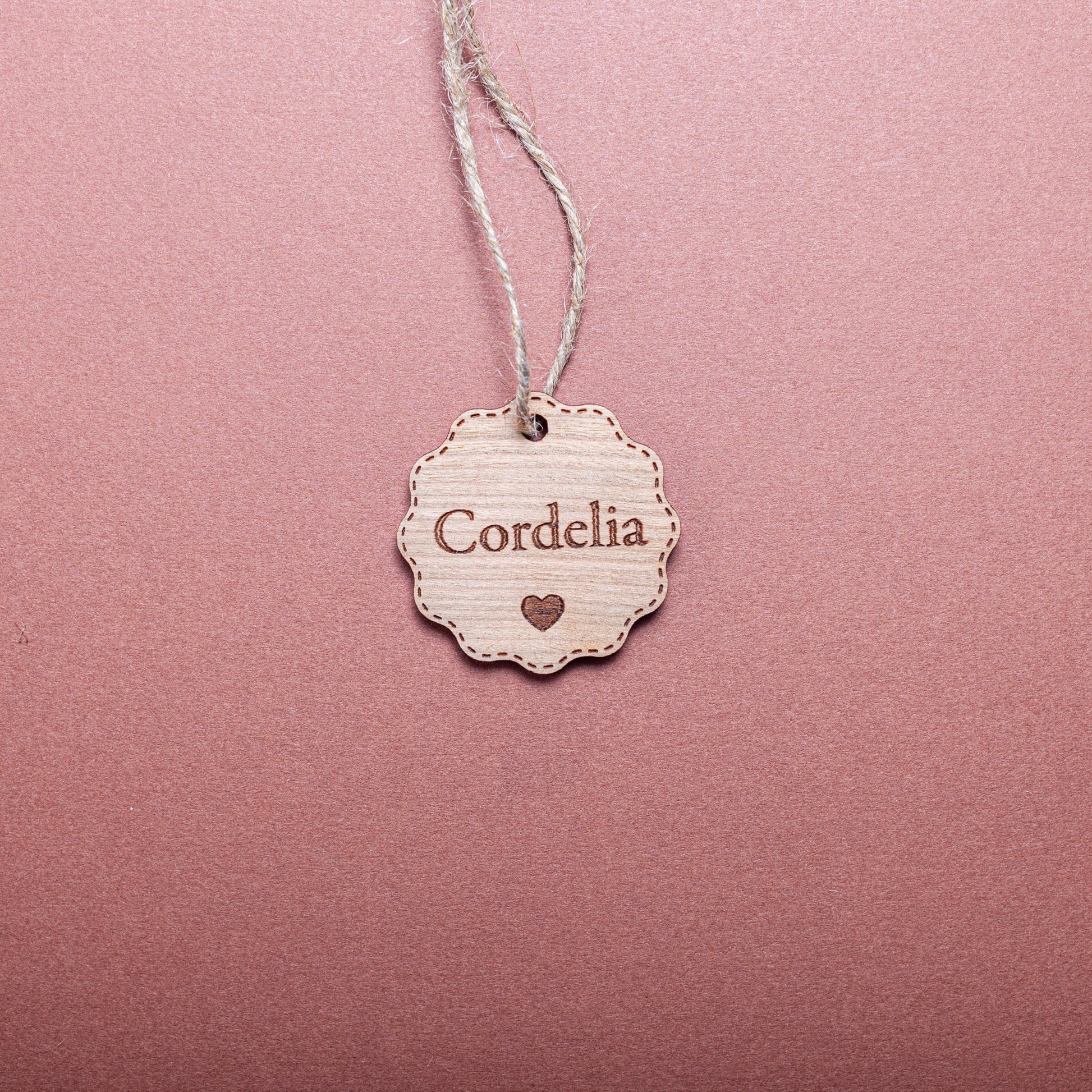 Rustic personalised bauble-shaped wooden tag for holiday wrapping