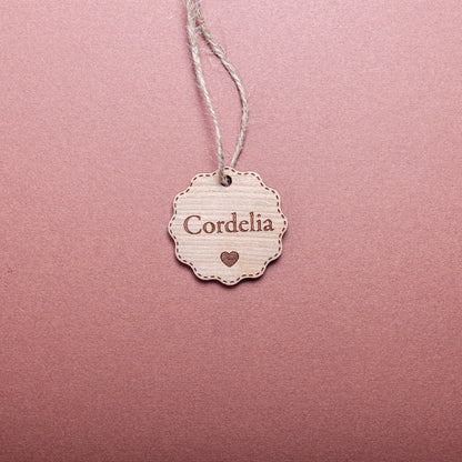 Rustic personalised bauble-shaped wooden tag for holiday wrapping