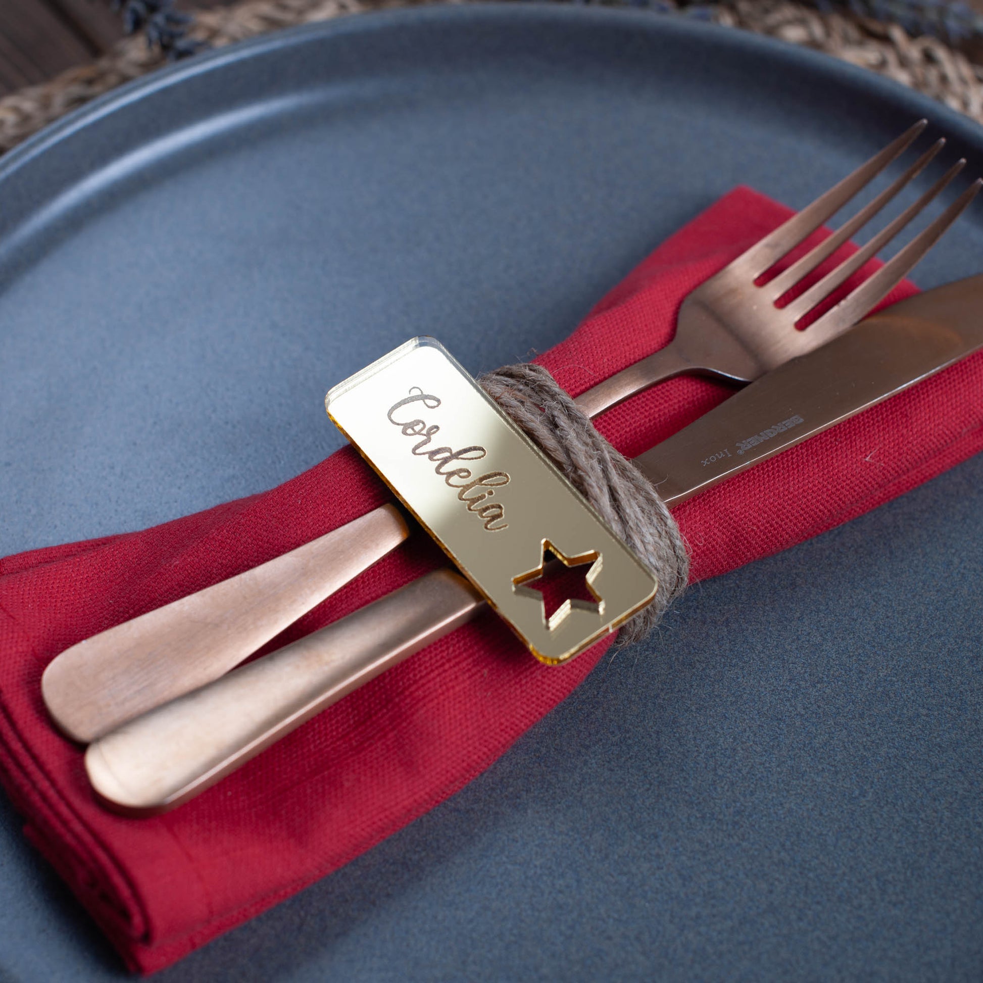 Engraved rectangular Christmas place card featuring custom guest name and star cutout detail