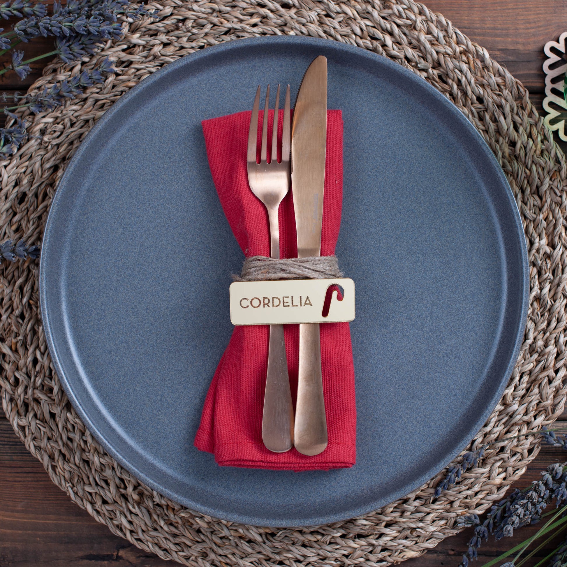 Engraved rectangular Christmas place card featuring custom guest name and festive candy cane cutout