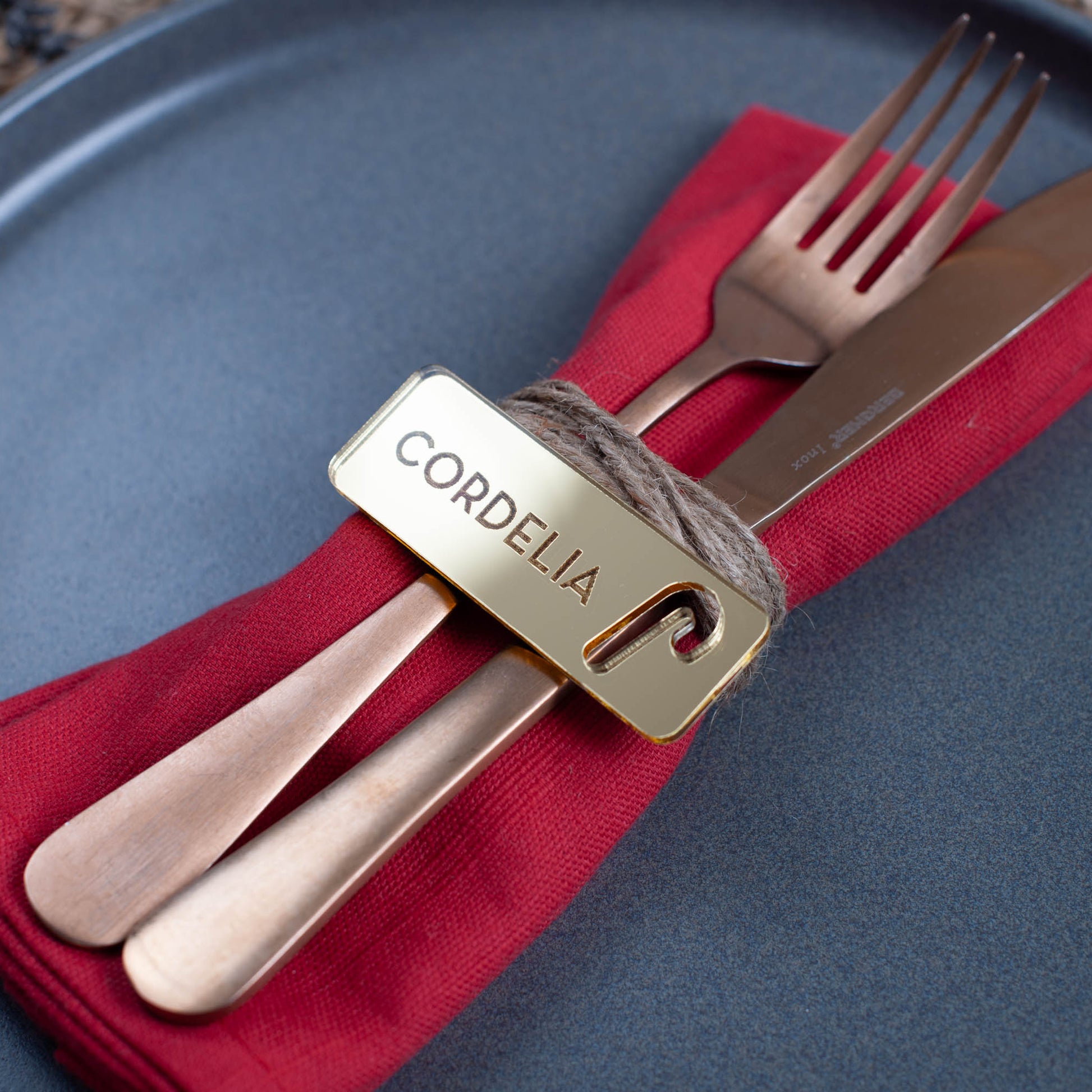 Custom laser cut Christmas place setting with intricate candy cane cutout in gold acrylic