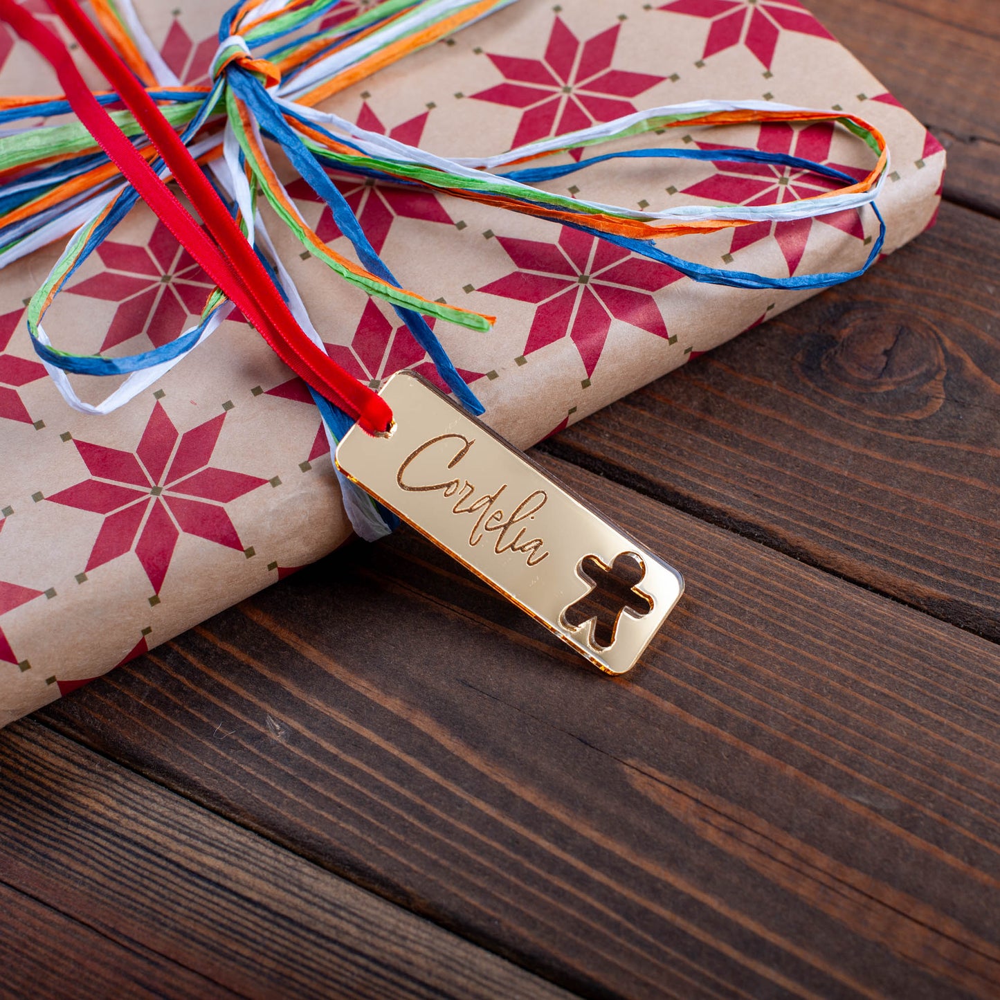 Personalised rectangular wooden Christmas gift tag with festive ornament cutouts