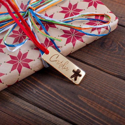 Personalised rectangular wooden Christmas gift tag with festive ornament cutouts