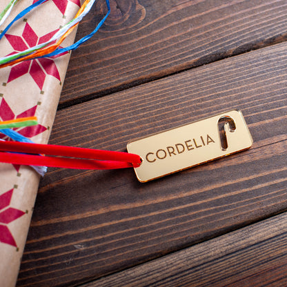 Custom wooden Christmas gift tag engraved with name and festive details