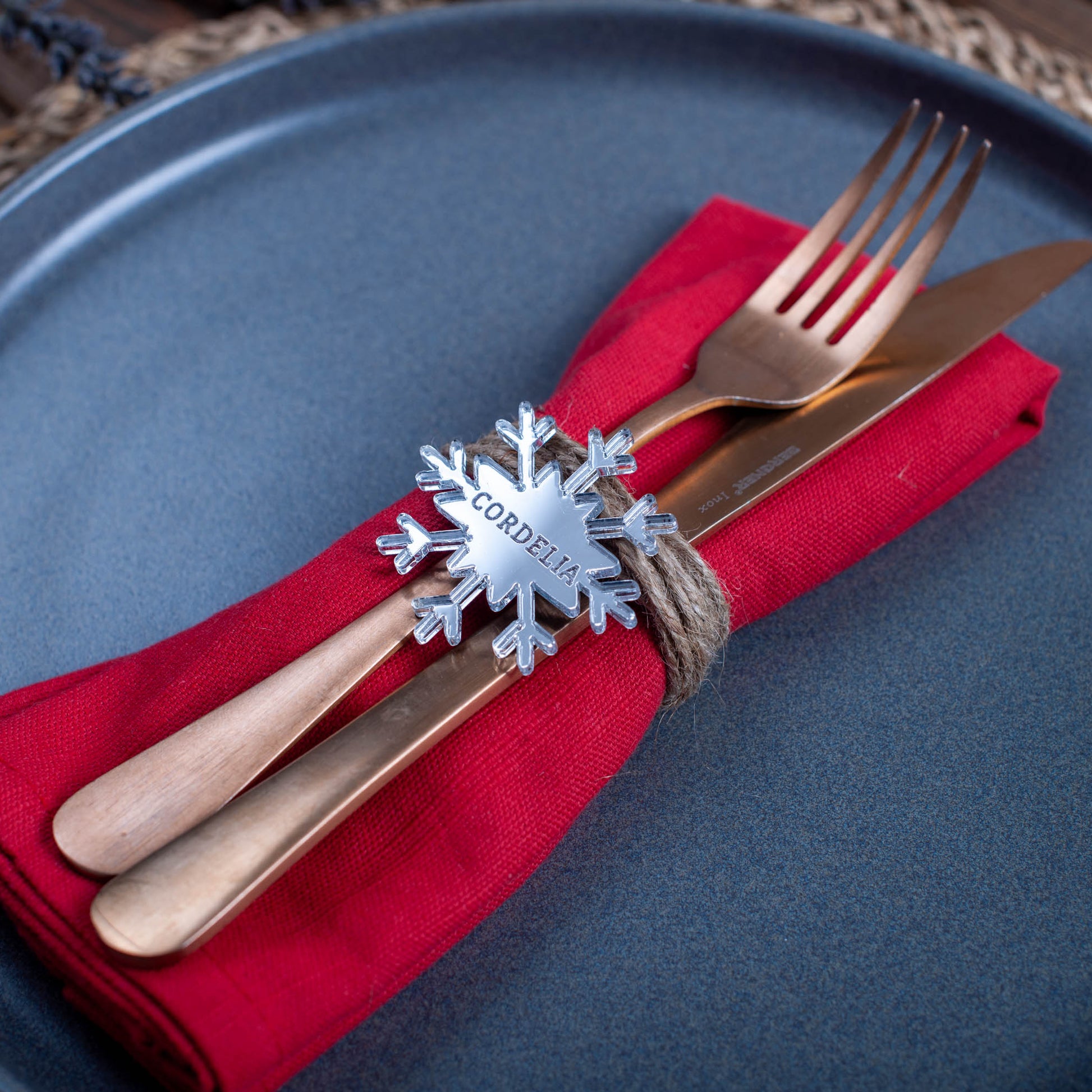 Laser-cut silver mirror snowflake place setting for festive dinner table