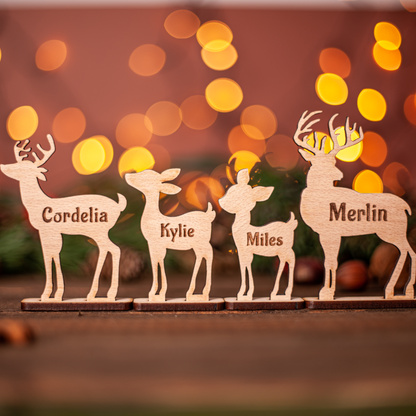 Wooden deer figurines with names against a blurred bokeh light background