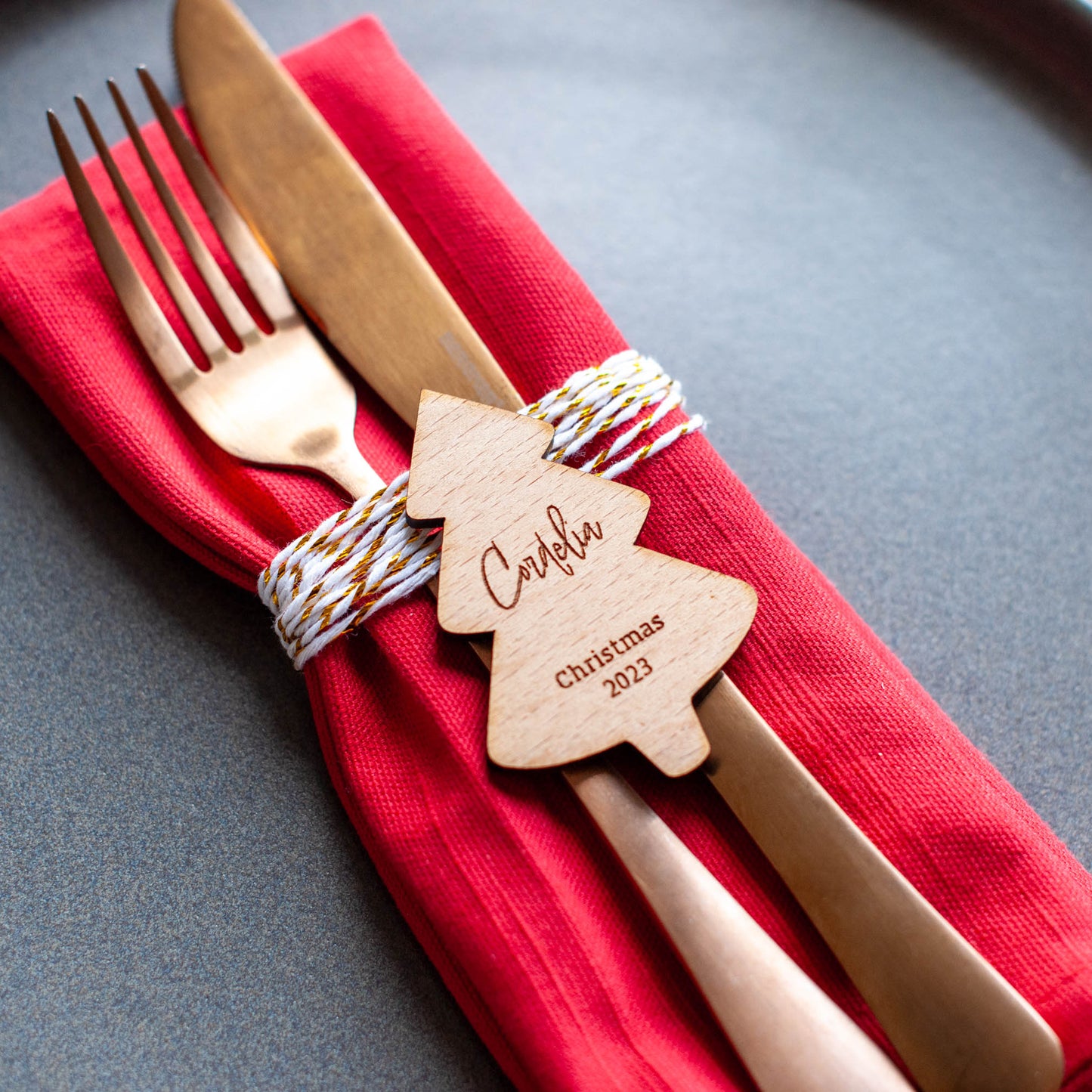 Personalised family Christmas decorations laid out on holiday dinner table