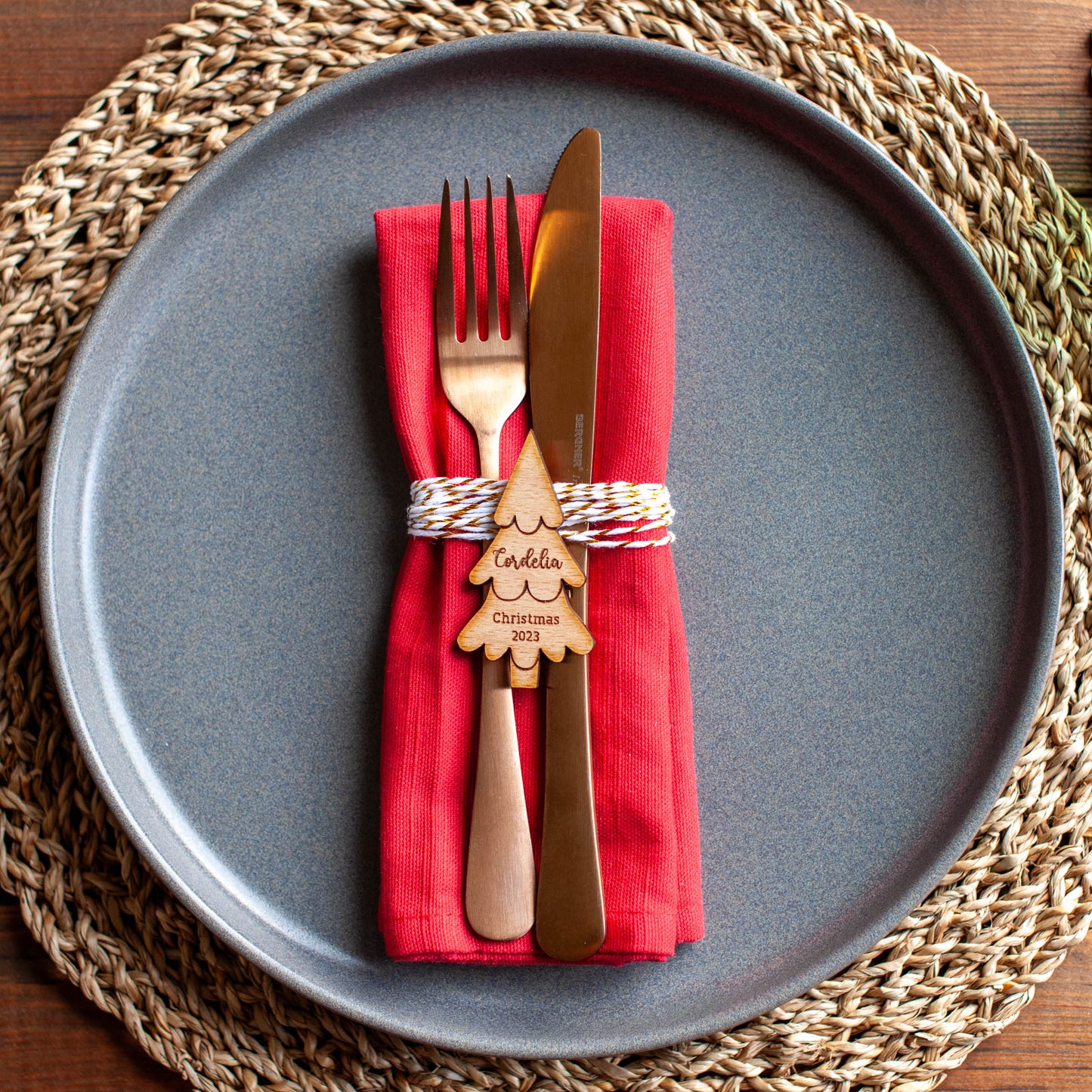 Close-up of engraved Christmas tree place card with custom guest name