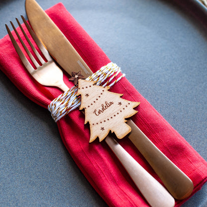 Personalised Christmas tree place name decoration on festive dinner table