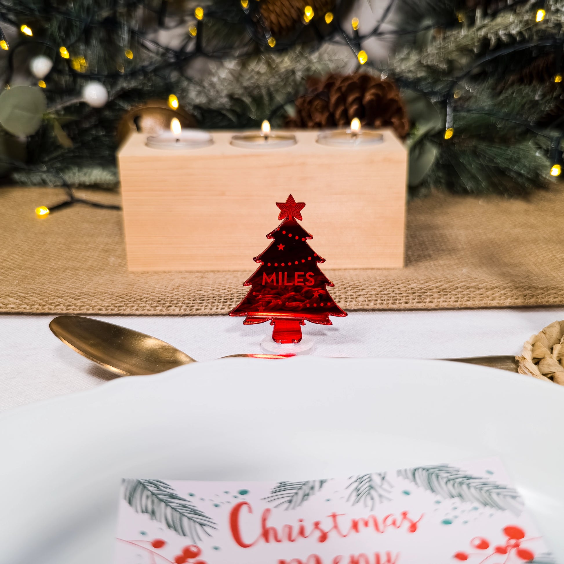 Red mirror tree place setting engraved with guest’s name