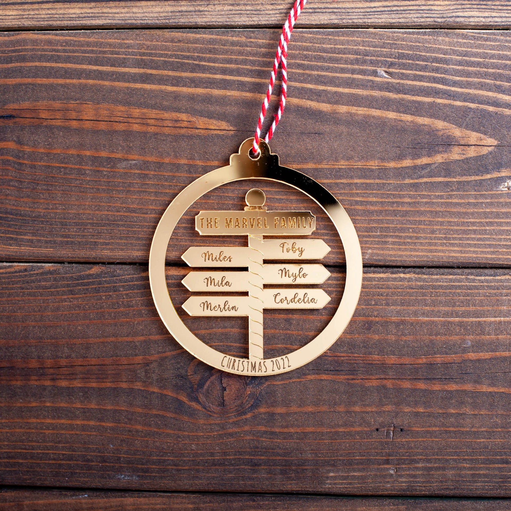 Engraved mirror acrylic Christmas ornament featuring laser-cut names