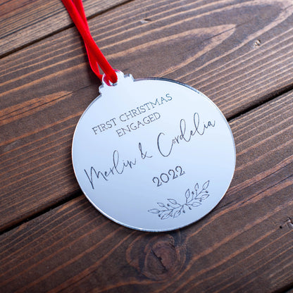 Personalised silver acrylic bauble celebrating first Christmas engaged