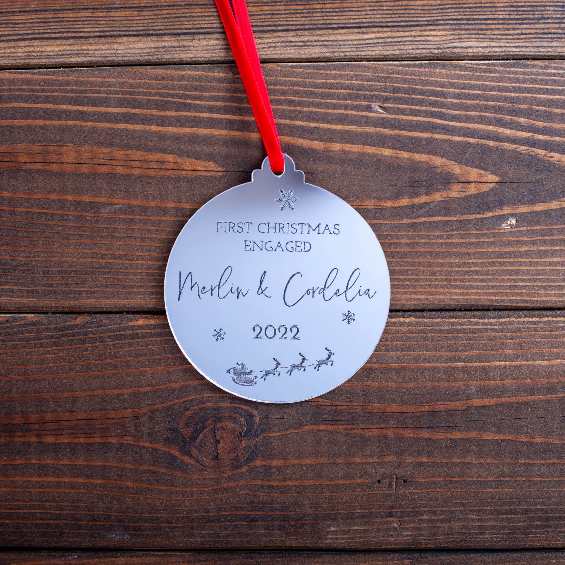 Elegant silver Christmas bauble with engraved names and hearts