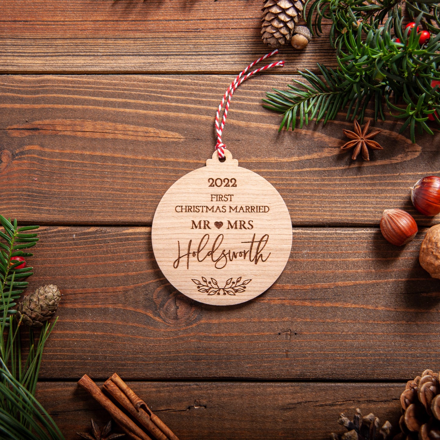 Rustic wooden Christmas bauble celebrating first Christmas married