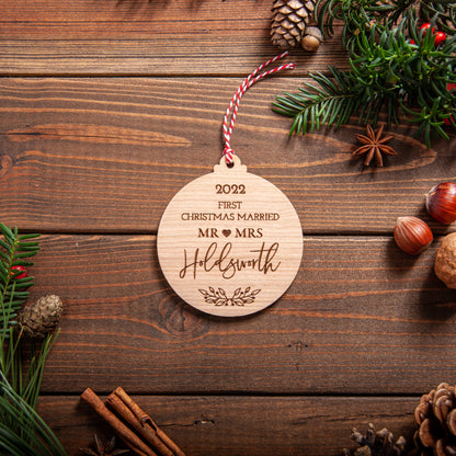 Rustic wooden Christmas bauble celebrating first Christmas married