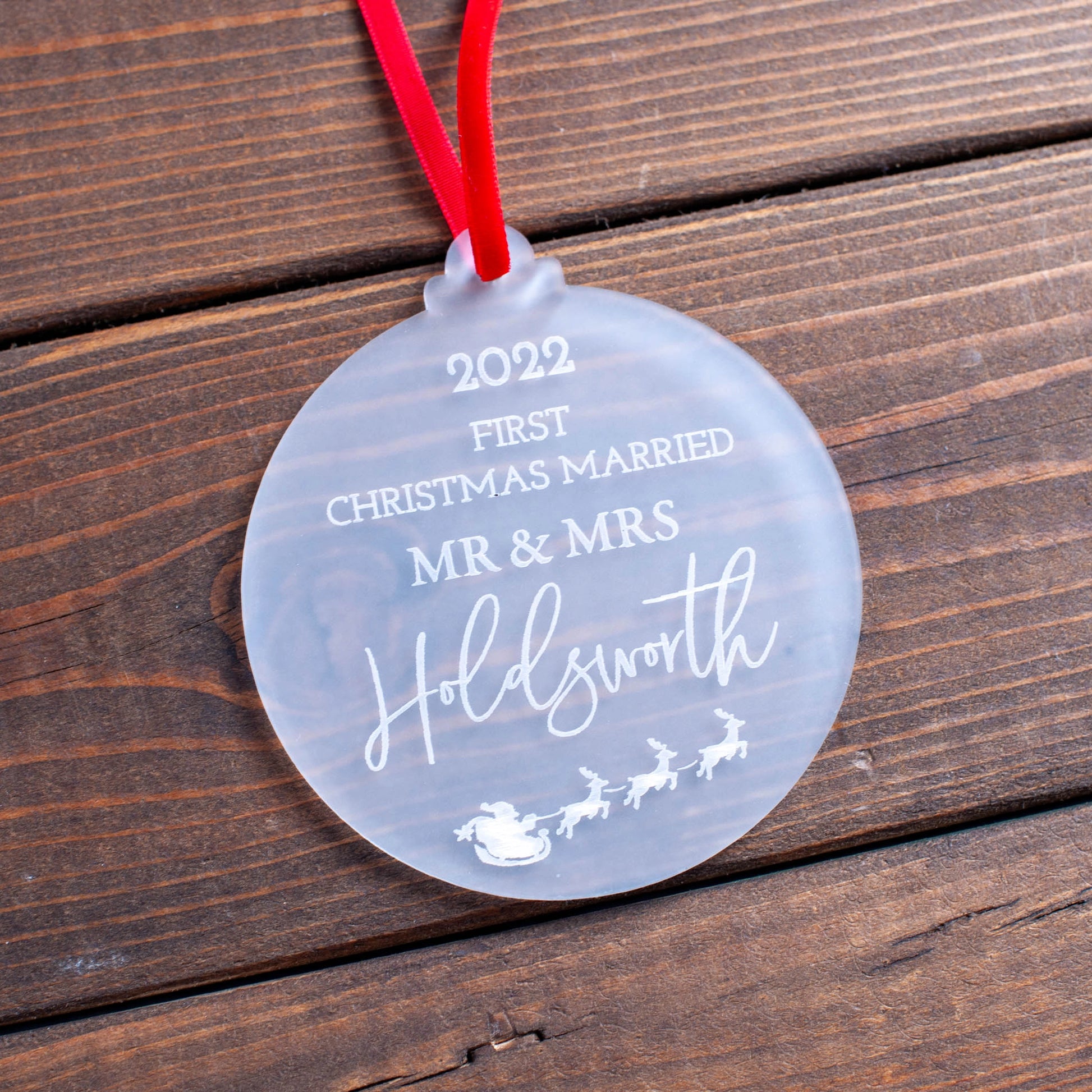 Frosted acrylic ornament engraved with married couple’s names and year